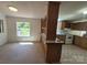 Eat-in kitchen featuring custom cabinetry, open view window, and laminate flooring at 44112 Harper Hearne Rd, New London, NC 28127