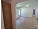 Open floor plan living room with neutral carpet and an adjoining room at 44112 Harper Hearne Rd, New London, NC 28127