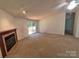 Cozy living room with a fireplace, large picture window and neutral colored walls at 44112 Harper Hearne Rd, New London, NC 28127