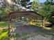 A gravel parking area under a metal carport, providing ample space for vehicles and outdoor storage at 44112 Harper Hearne Rd, New London, NC 28127