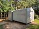 Exterior view of metal storage sheds nestled among the trees in the yard at 44112 Harper Hearne Rd, New London, NC 28127