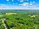 Picturesque aerial view showcasing a vast landscape of lush greenery, trees, and open land at 485 Johnson St, China Grove, NC 28023
