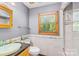 Modern bathroom with white marble, walk-in shower, sink and wood-look blinds, perfect for relaxing at 485 Johnson St, China Grove, NC 28023