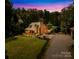 Scenic twilight view of home, showcasing the charming exterior, covered porch, and lush surrounding landscape at 485 Johnson St, China Grove, NC 28023