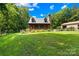 Charming two-story log home with a cozy front porch and landscaped yard on a sunny day at 485 Johnson St, China Grove, NC 28023
