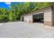 Detached garage with ample parking and storage space on a fully graveled parking pad at 485 Johnson St, China Grove, NC 28023