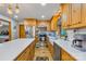Bright kitchen featuring wooden cabinets, stainless steel appliances, and an island with quartz countertops at 485 Johnson St, China Grove, NC 28023