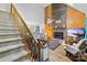 Cozy living room features a brick fireplace, wood paneling, and staircase, perfect for relaxing and entertaining at 485 Johnson St, China Grove, NC 28023