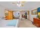 Relaxing bedroom with neutral carpet, mirrored closet doors, ceiling fan, and access to ensuite bathroom at 485 Johnson St, China Grove, NC 28023