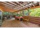 Large enclosed porch featuring wood beam ceiling and views of the surrounding greenery at 485 Johnson St, China Grove, NC 28023