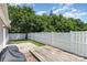 Charming backyard with a wooden deck, concrete patio area, and privacy fence at 4894 Prowess Ln, Indian Land, SC 29707