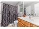Full bathroom including vanity with mirror and shower with black and white curtain at 4894 Prowess Ln, Indian Land, SC 29707