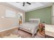 This bedroom with green accent wall includes bed, desk, and ensuite bathroom at 4894 Prowess Ln, Indian Land, SC 29707