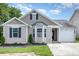 Charming single-Gathering home featuring manicured lawn, neutral siding, and attached one-car garage at 4894 Prowess Ln, Indian Land, SC 29707