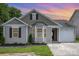Charming single-Gathering home featuring manicured lawn, neutral siding, and attached one-car garage at 4894 Prowess Ln, Indian Land, SC 29707