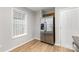 Spacious kitchen featuring stainless steel refrigerator, wood floors, and white cabinets at 4894 Prowess Ln, Indian Land, SC 29707
