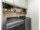 A laundry room offers modern appliances and decorative shelves at 4894 Prowess Ln, Indian Land, SC 29707