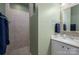 Neutral bathroom features a walk-in shower and a stylish vanity with framed mirror at 5268 Courtyard Ln, Belmont, NC 28012