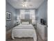 Cozy bedroom with soft blue walls, a ceiling fan, and a comfortable queen-sized bed at 5268 Courtyard Ln, Belmont, NC 28012