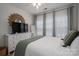 Inviting bedroom featuring a large window, dresser with a mirror, and decorative accents at 5268 Courtyard Ln, Belmont, NC 28012