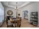 Dining room with wooden table, chandelier, and view into Primary bedroom at 5268 Courtyard Ln, Belmont, NC 28012