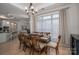 Dining room with large window, wood table with seating for eight and access to kitchen at 5268 Courtyard Ln, Belmont, NC 28012