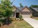 Inviting brick home with an attached garage, neat landscaping, and a welcoming front entrance at 5268 Courtyard Ln, Belmont, NC 28012