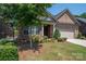 Beautiful brick home with a well-kept front yard, mature trees, and a charming covered entrance at 5268 Courtyard Ln, Belmont, NC 28012