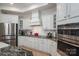 Modern kitchen features custom white cabinetry, stainless steel appliances, and granite countertops at 5268 Courtyard Ln, Belmont, NC 28012