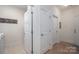 Bright laundry area with white trim, tiled floor, and multiple doors for easy access and convenience at 5268 Courtyard Ln, Belmont, NC 28012