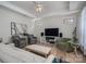 Spacious living room featuring hardwood floors, a ceiling fan and neutral color palette at 5268 Courtyard Ln, Belmont, NC 28012