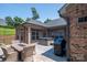 Brick home exterior with patio furniture, grill, hot tub, and an enclosed backyard at 5268 Courtyard Ln, Belmont, NC 28012