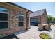 Brick home exterior with a gray paver patio, dining table, grill, and an enclosed backyard at 5268 Courtyard Ln, Belmont, NC 28012