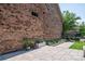 Brick home exterior with a gray paver patio, green plants, and a black metal fence at 5268 Courtyard Ln, Belmont, NC 28012