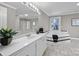 Spacious bathroom features a white vanity, large mirror, soaking tub, and checkered tile flooring at 550 Woodleaf Barber Rd, Cleveland, NC 27013