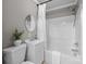 Clean bathroom featuring a tub with shower, a sink with cabinet and a round mirror at 550 Woodleaf Barber Rd, Cleveland, NC 27013