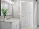 Modern bathroom with a marble vanity, updated lighting, and neutral colors, with access to hall storage at 550 Woodleaf Barber Rd, Cleveland, NC 27013