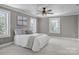Bright bedroom with neutral walls, carpet, a ceiling fan, and two windows with natural light at 550 Woodleaf Barber Rd, Cleveland, NC 27013