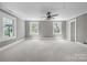 Spacious bedroom with neutral tones, modern ceiling fan, new carpet, and abundant natural light at 550 Woodleaf Barber Rd, Cleveland, NC 27013