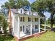 Elevated view of a stately two-story home with white siding, black shutters, and a full-length front porch at 550 Woodleaf Barber Rd, Cleveland, NC 27013