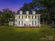 Beautiful two story traditional home with white siding, black shutters, and an inviting front porch at 550 Woodleaf Barber Rd, Cleveland, NC 27013