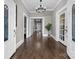 Inviting foyer boasts gleaming hardwood floors and classic chandelier lighting, showcasing seamless transitions at 550 Woodleaf Barber Rd, Cleveland, NC 27013