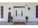 Charming front entrance with double doors, classic sconces, and decorative greenery at 550 Woodleaf Barber Rd, Cleveland, NC 27013
