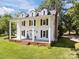 Classic white facade featuring dormer windows, black shutters, and inviting front porch with white support columns at 550 Woodleaf Barber Rd, Cleveland, NC 27013