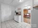 Hallway with tile flooring leading to a separate office space at 550 Woodleaf Barber Rd, Cleveland, NC 27013