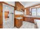 The kitchen has wood cabinets, white countertops, and tile floors at 550 Woodleaf Barber Rd, Cleveland, NC 27013