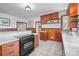Well-lit kitchen with wood accents and tile flooring at 550 Woodleaf Barber Rd, Cleveland, NC 27013