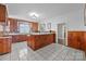 Spacious kitchen featuring wood paneling, white countertops, and checkered tile floor at 550 Woodleaf Barber Rd, Cleveland, NC 27013