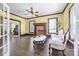 Living room featuring a red brick fireplace, hardwood floors, and a ceiling fan at 550 Woodleaf Barber Rd, Cleveland, NC 27013