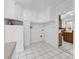 Functional utility room with white cabinetry and tile flooring at 550 Woodleaf Barber Rd, Cleveland, NC 27013